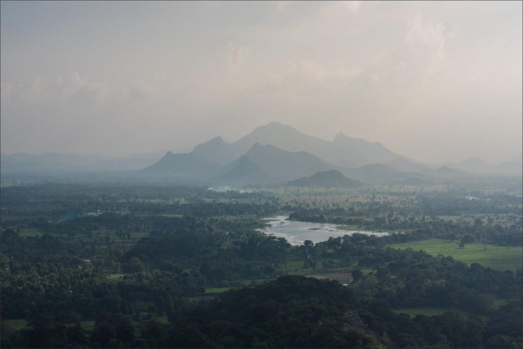 Sri Lanka photographer: panoramic misty landscape of the lake and majestic mountains.