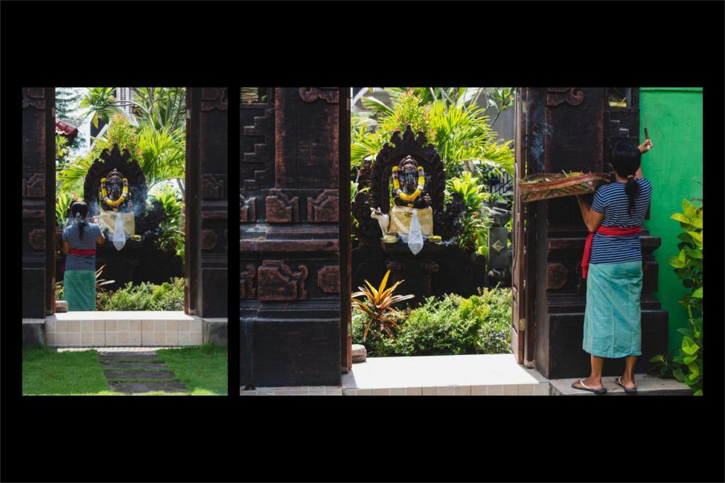 Photographer Bali: the shrine and offerings captured through the door.