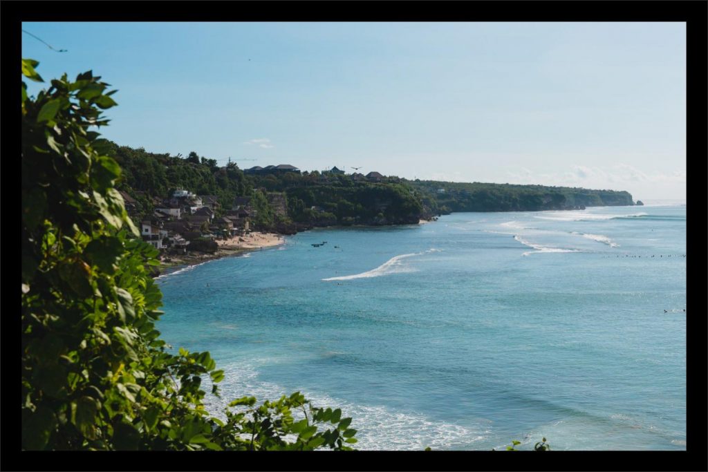 Bali Uluwatu wedding: ocean views with cliffs and surfers.