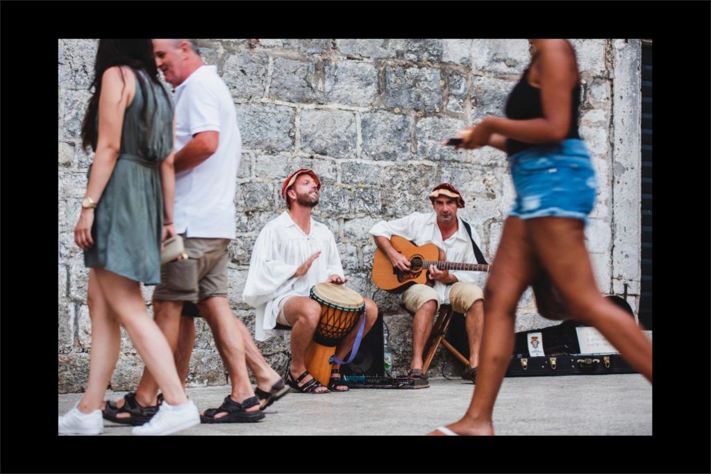Croatia wedding photographer: local singers with the Dubrovnik city walls.