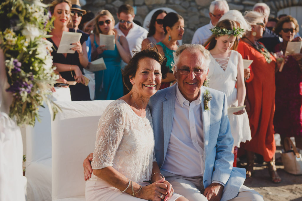 Wedding photographer Mykonos: proud parents smiling during  Mykonos wedding.