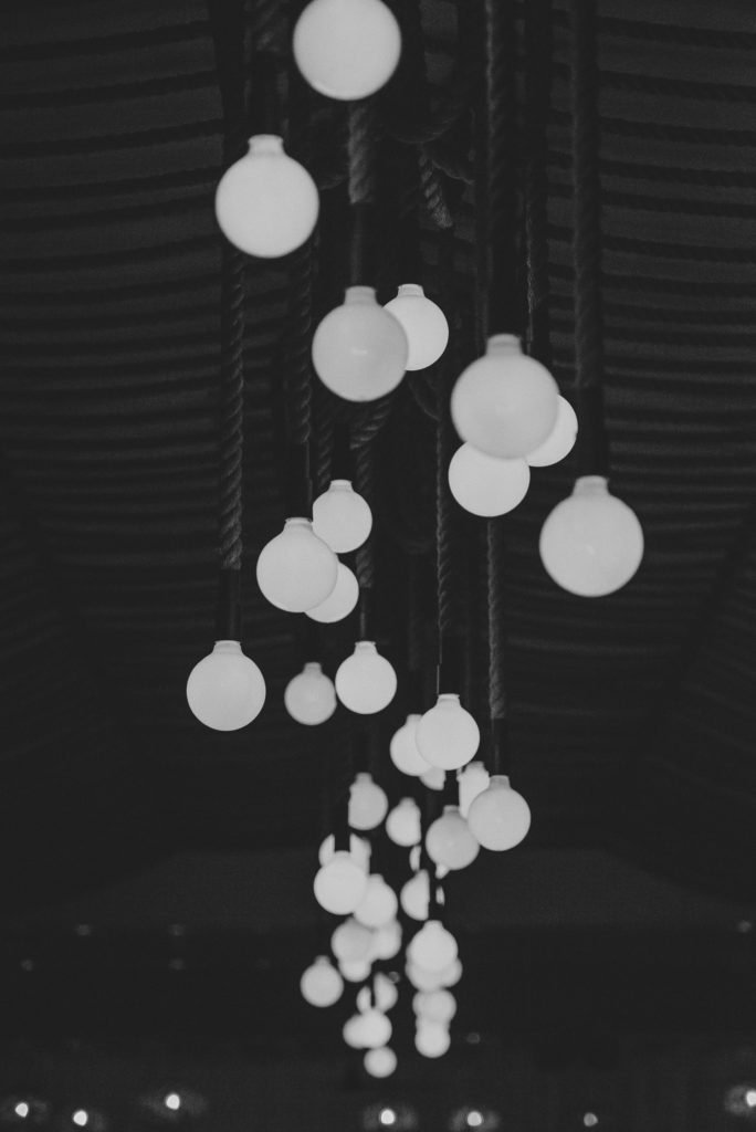 Wedding photographer Mykonos: black and white photo of wedding lights at Elia for Mykonos wedding.
