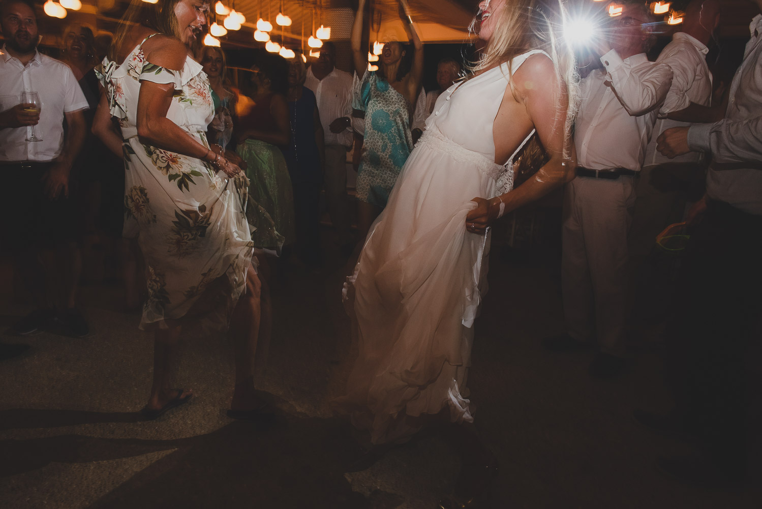 Wedding photographer Mykonos: wild dancing at Elia during Mykonos wedding.