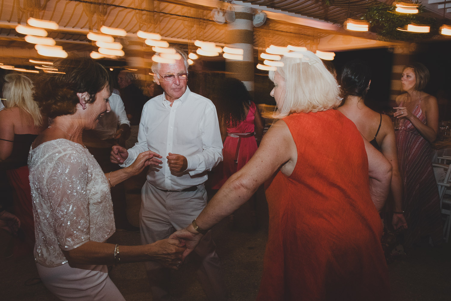 Wedding photographer Mykonos: parents dancing at Elia during Mykonos wedding.