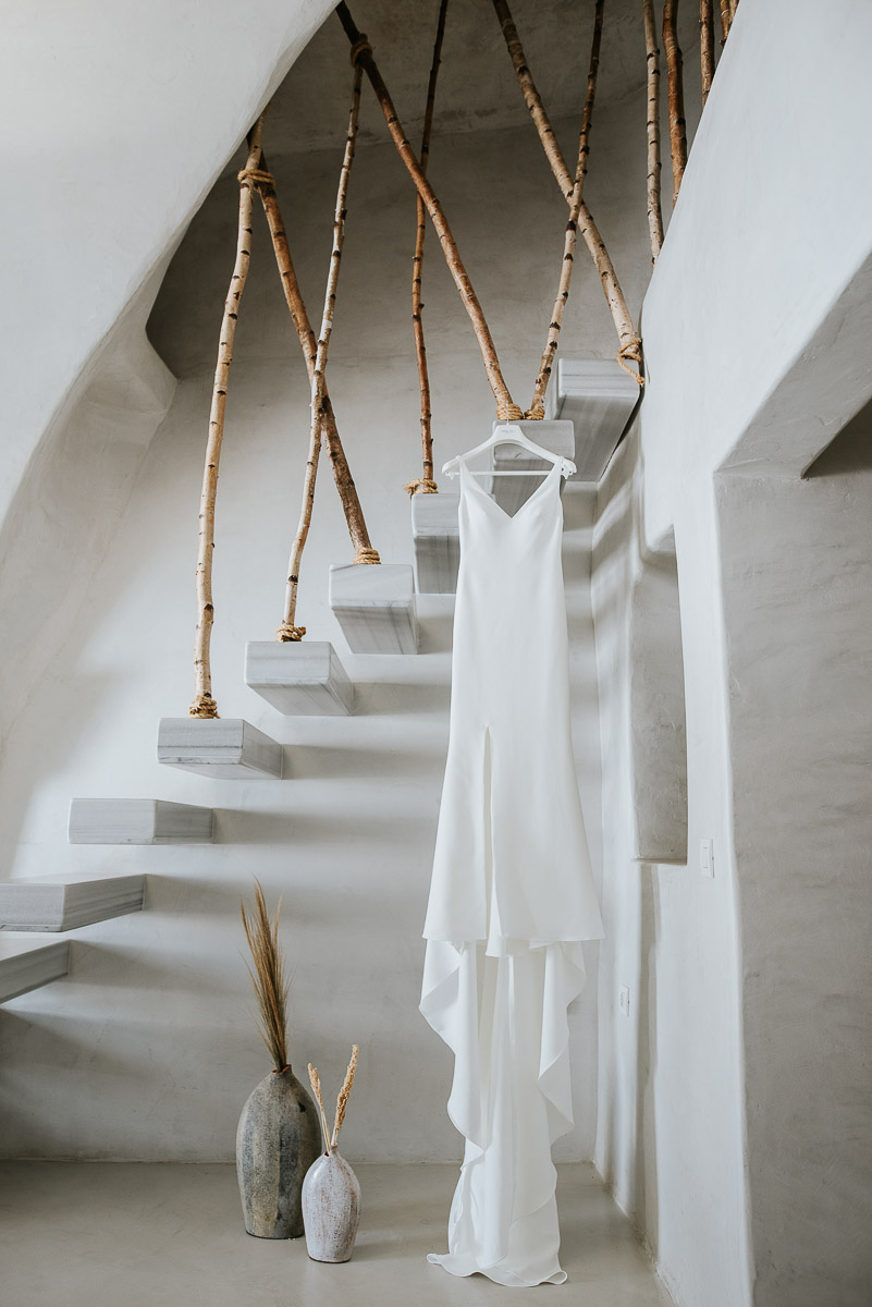 Santorini elopement photographer: wedding dress in Oia suite by Ben and Vesna.