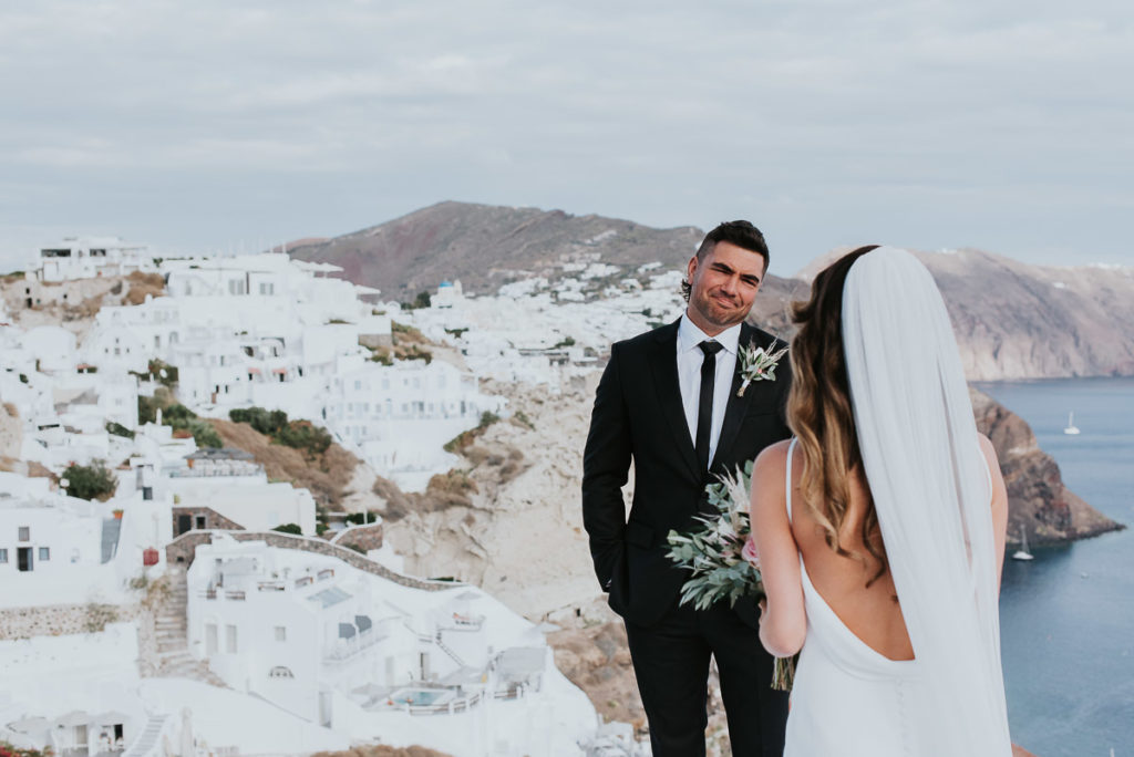 Santorini elopement photographer: first look with the Oia views by Ben and Vesna.