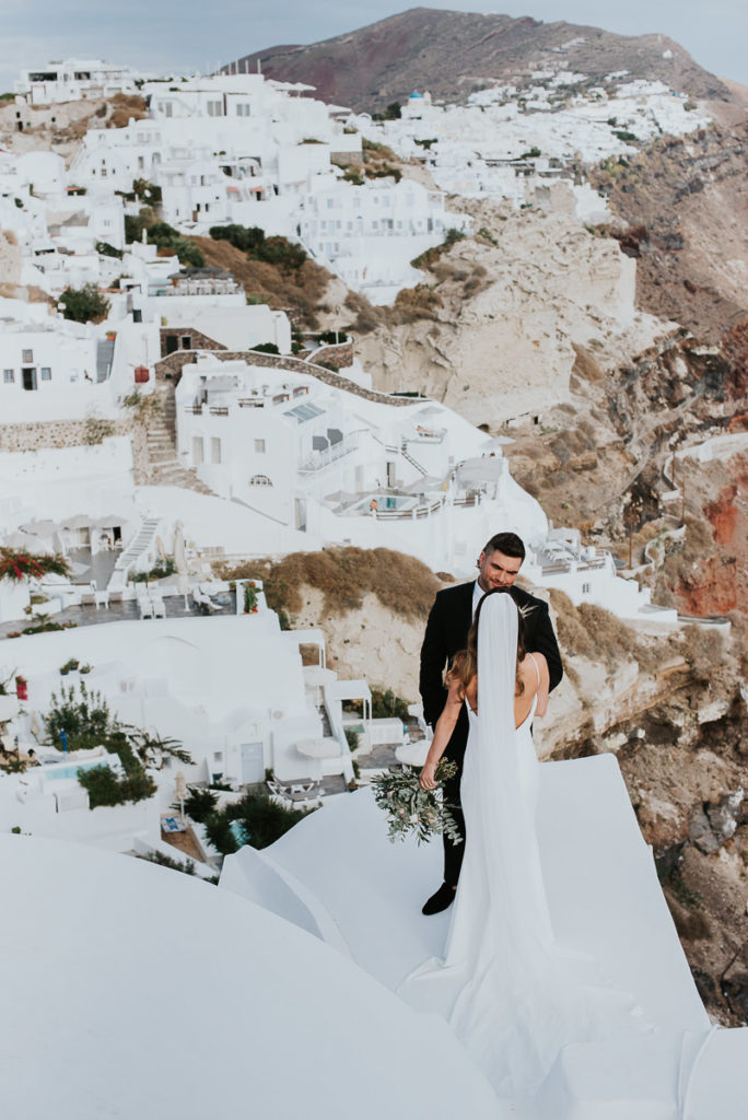 Santorini elopement photographer: first look with the Oia views by Ben and Vesna.