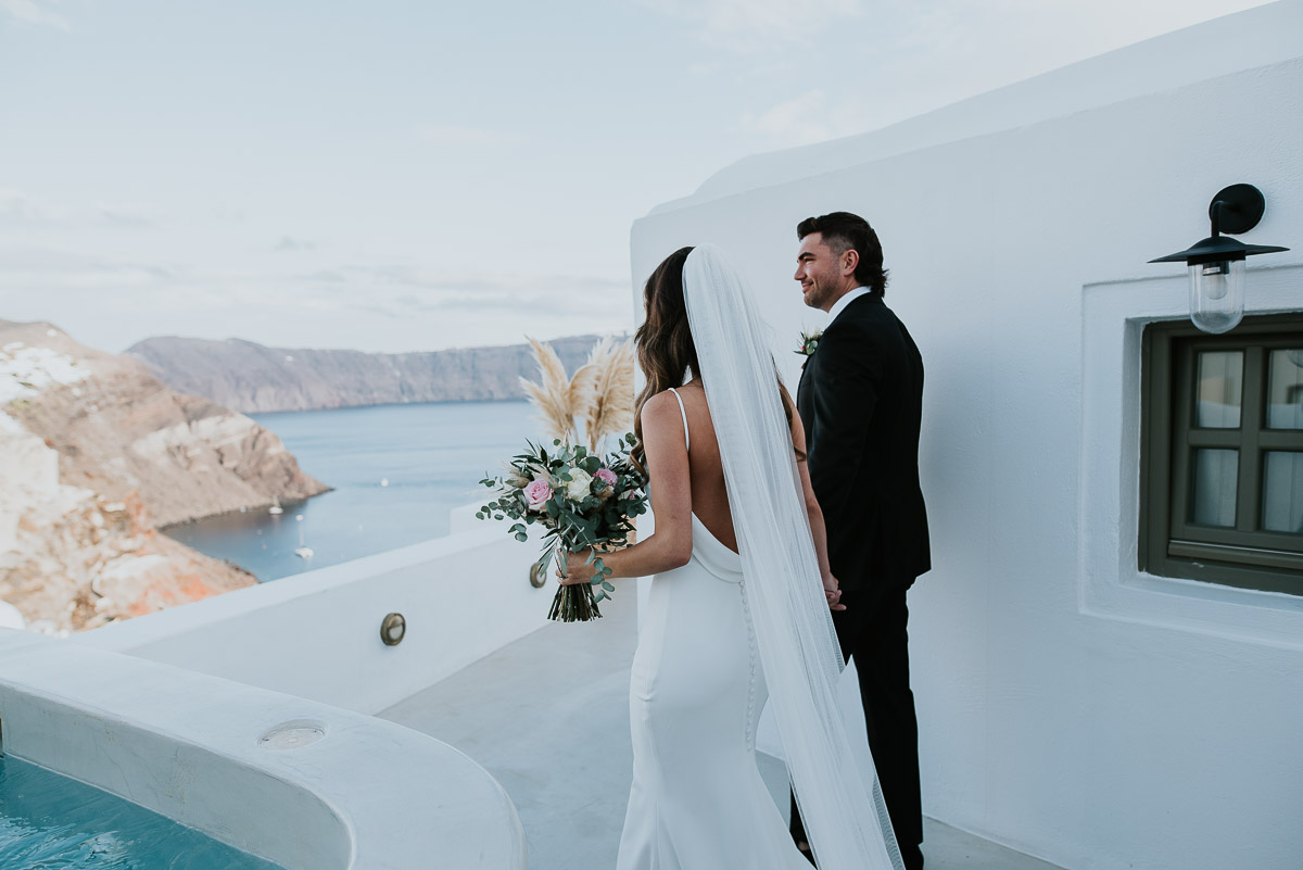 Santorini elopement photographer: couple walking down the aisle by Ben and Vesna.