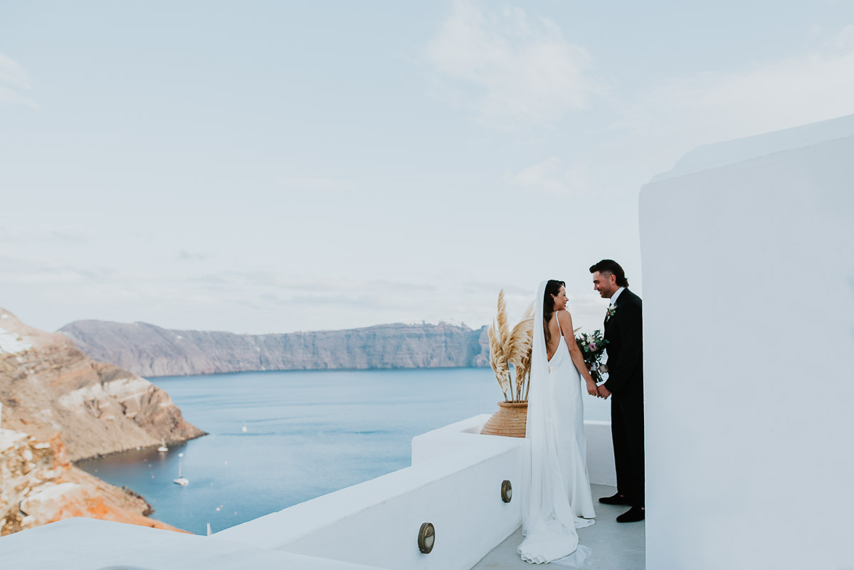 Santorini elopement photographer: couple walking down the aisle by Ben and Vesna.