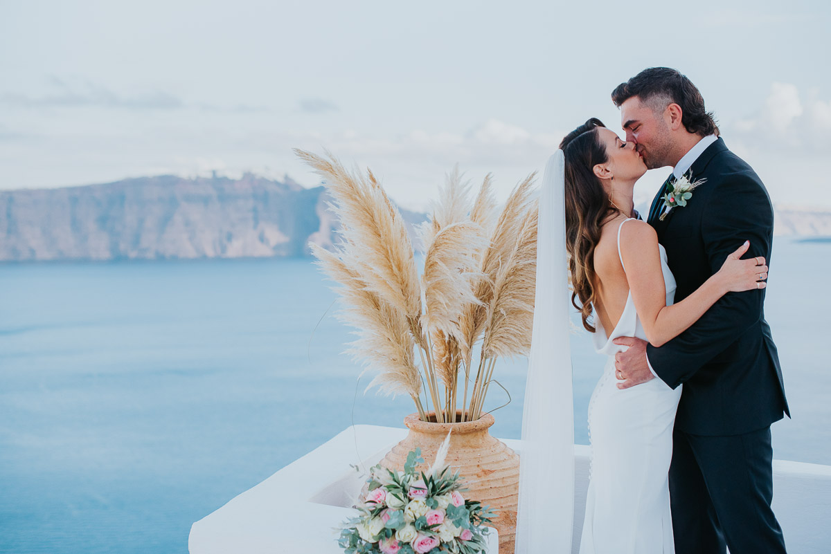 Santorini elopement photographer: couple's first kiss by Ben and Vesna.