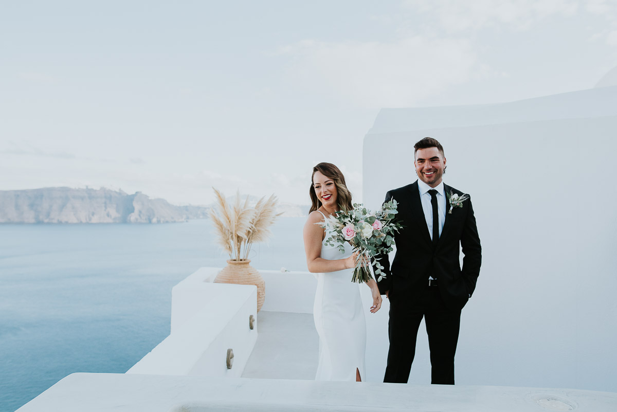 Santorini elopement photographer: couple smiling after the ceremony by Ben and Vesna.