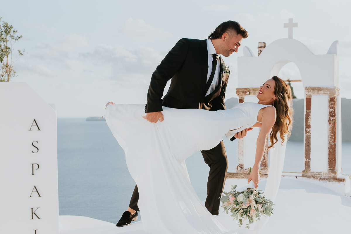 Santorini elopement photographer: the dip and the couple with the bell tower by Ben and Vesna.
