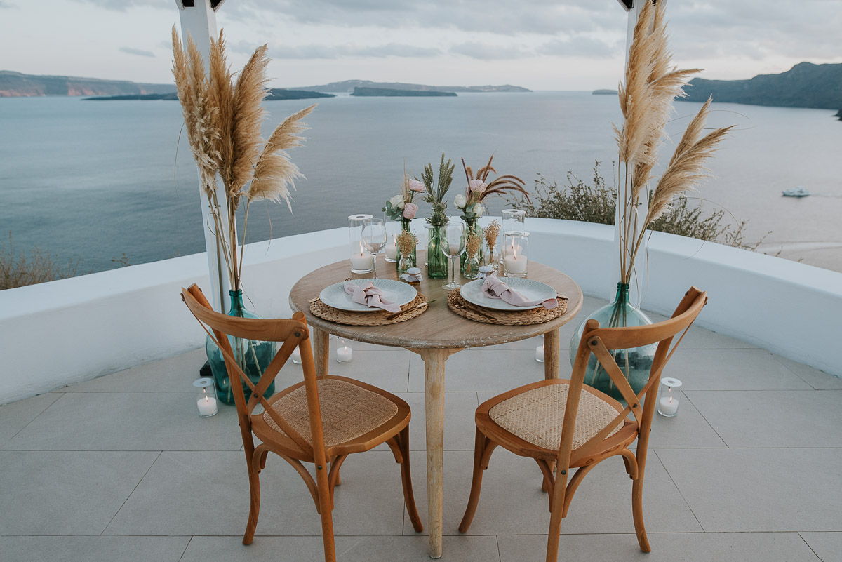 Santorini elopement photographer: the dinner setup with the views by Ben and Vesna.