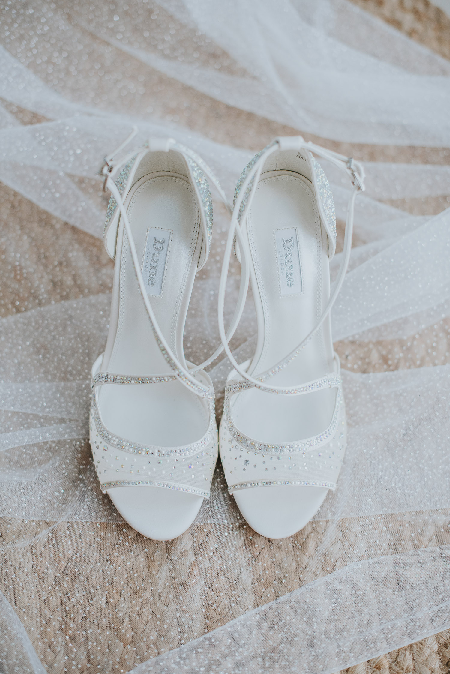 Rocabella Santorini Wedding: bride's details with her sparkling veil and Dune wedding shoes by Wedding photographer Santorini.